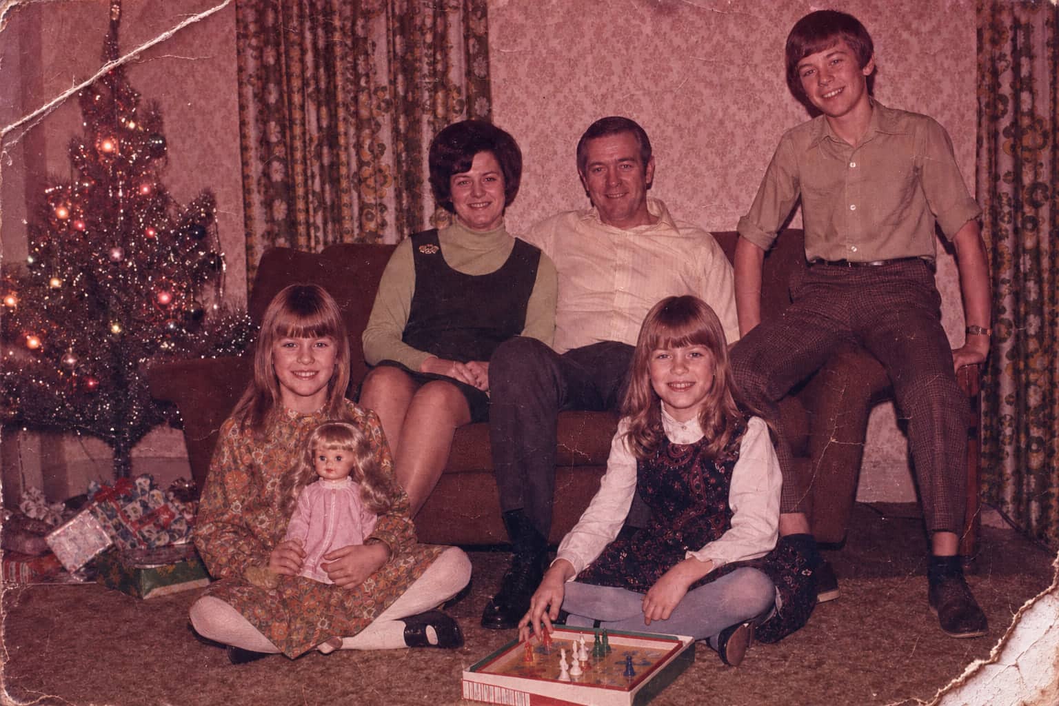 Creased 1971 living room photo with a heavy magenta cast before restoration.