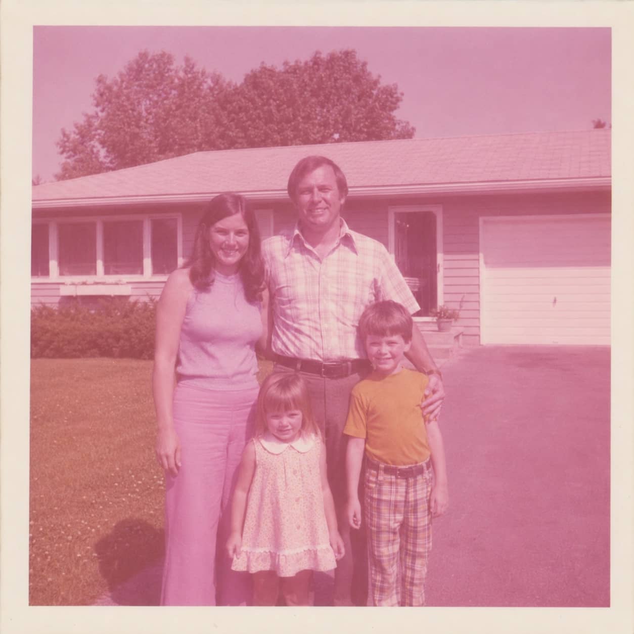 AI photo restoration app restoring faded color in an old family photo before