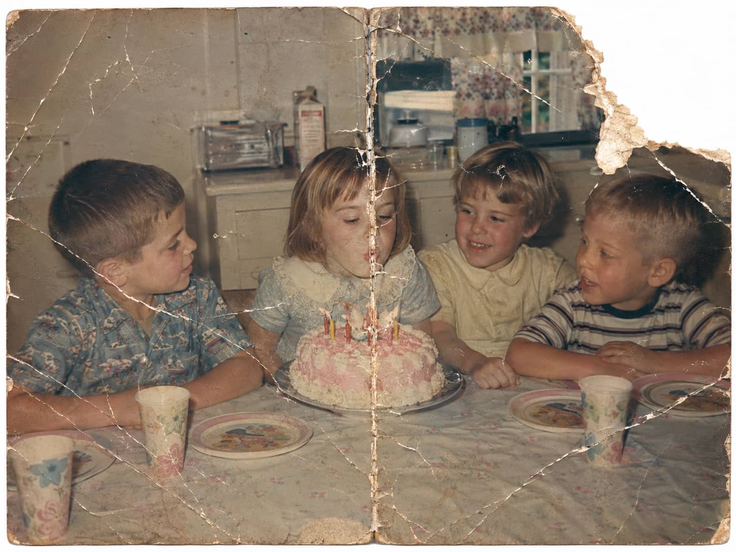 Torn birthday photo before restoration
